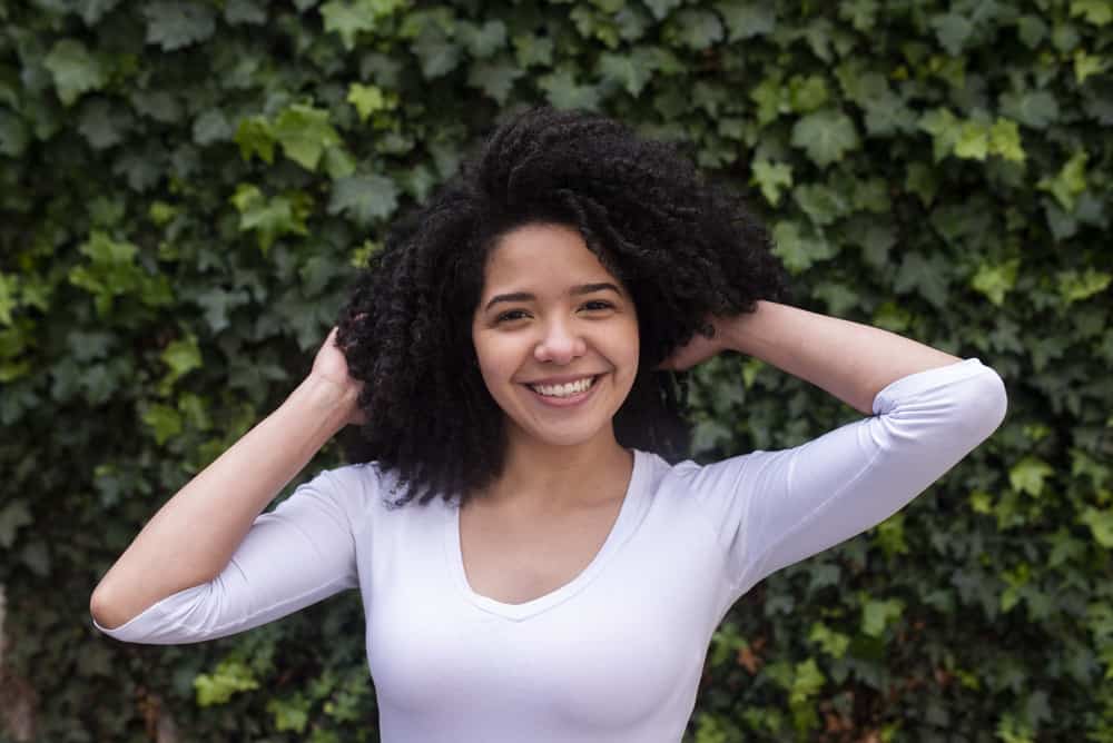 Latina female wearing a white shirt with natural hair in downtown NY city