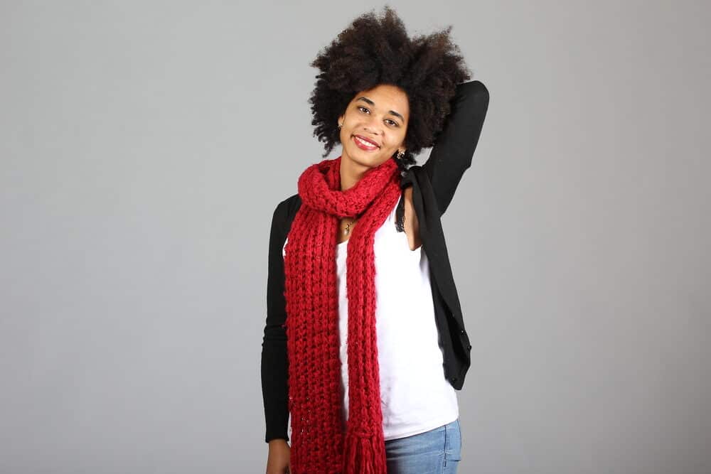 A woman with natural hair in an afro hairstyle wearing casual clothes.