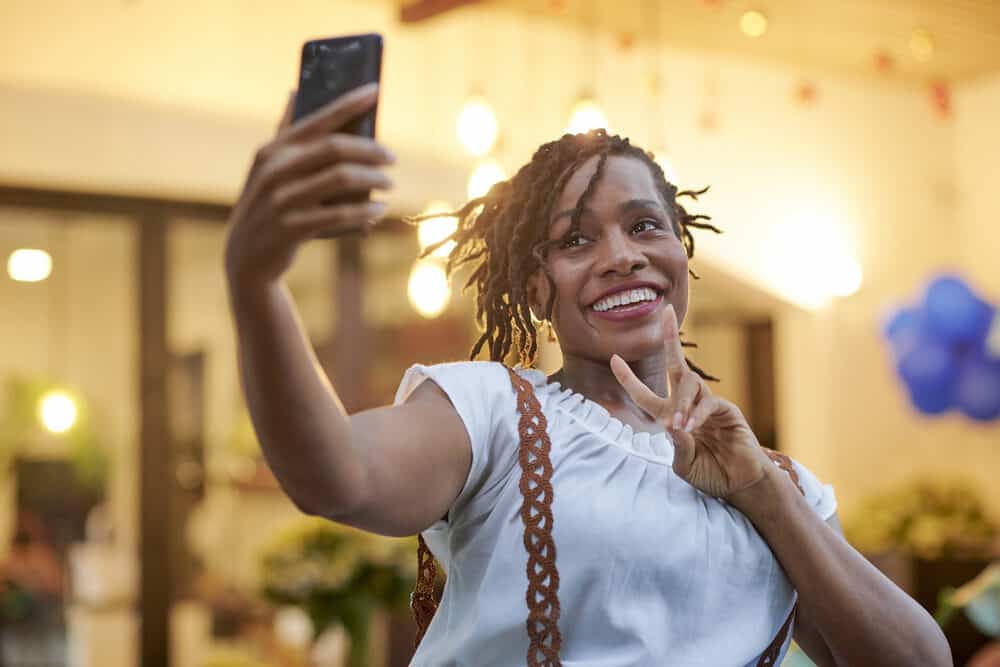 Women taking a selfie with a phone at an outdoor mall at World Market.