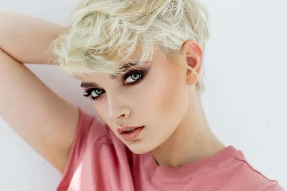 Dark blonde female used Wella toner to create ash blonde shade light hair color.