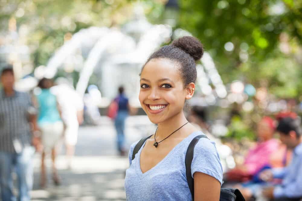 African female with lice-free curls after using powerful chemical substances to remove all the adult lice from her hair.