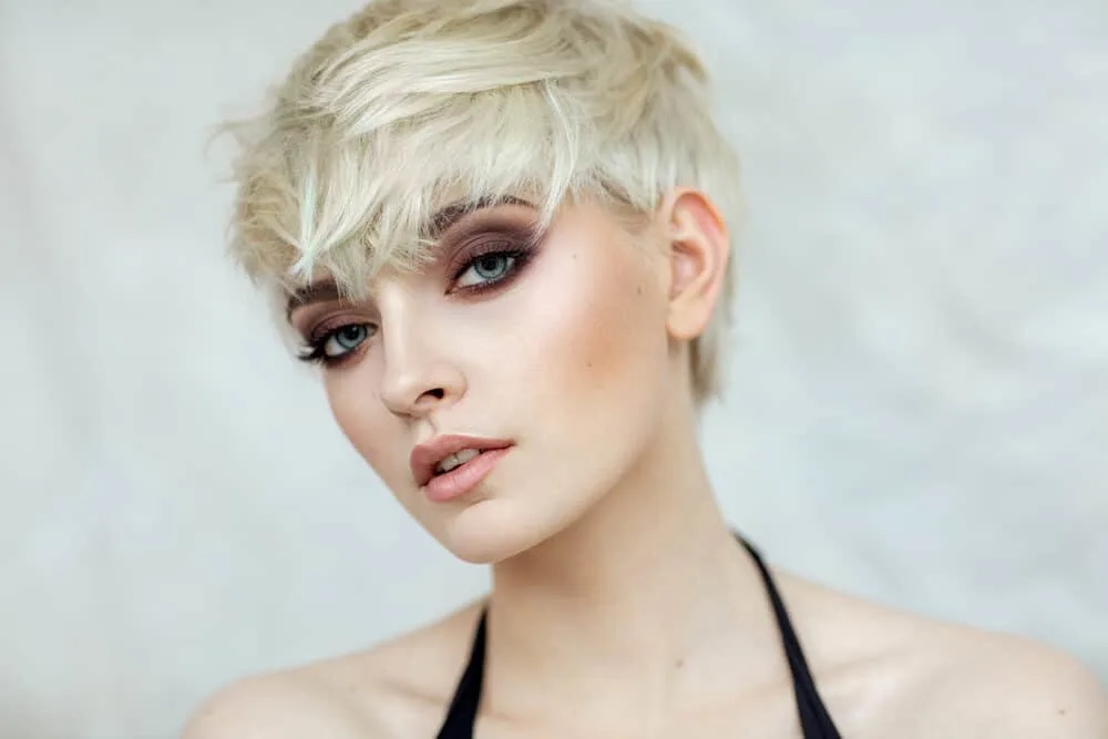 How Long Should I Leave Wella T18 Toner in My Hair? 6 Lady wearing a black dress, eye shadow, blush, and pink lipstick with golden brassy hair.