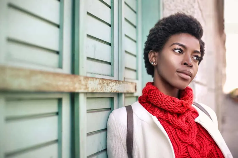 Is There a 4D Hair Type? Products, Maintenance, and Pictures 4 Female with a style that's off the hair type chart wearing a red sweater and white sports coat.