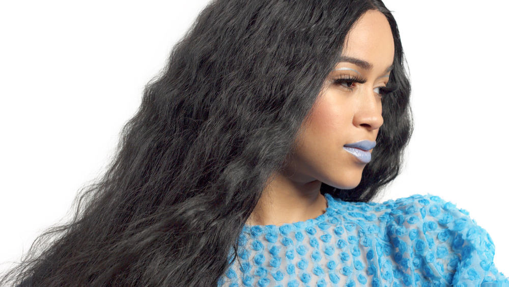 Pretty African American women with a blue dress, blue lipstick, and human hair extensions.