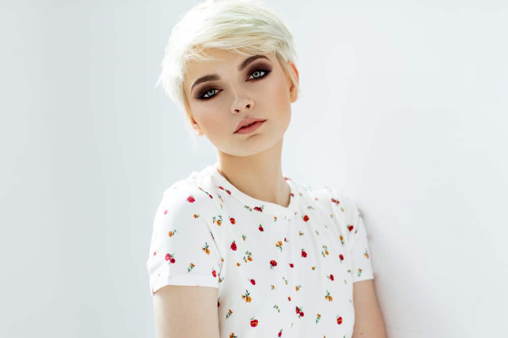 Natural blonde white female with type 1a towel-dried hair wearing a white t-shirt with flowers.