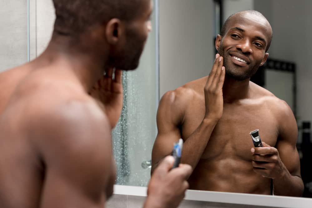Black guy shaving with a single variable detail trimmer head.