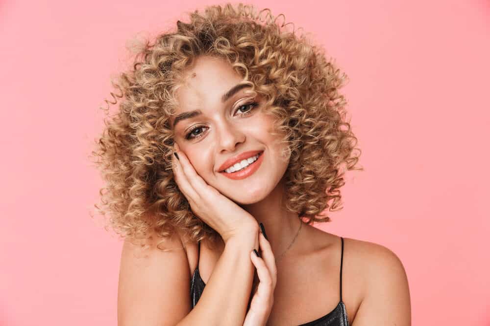 Gorgeous closeup of a white lady wearing an evening dress and naturally coily hair