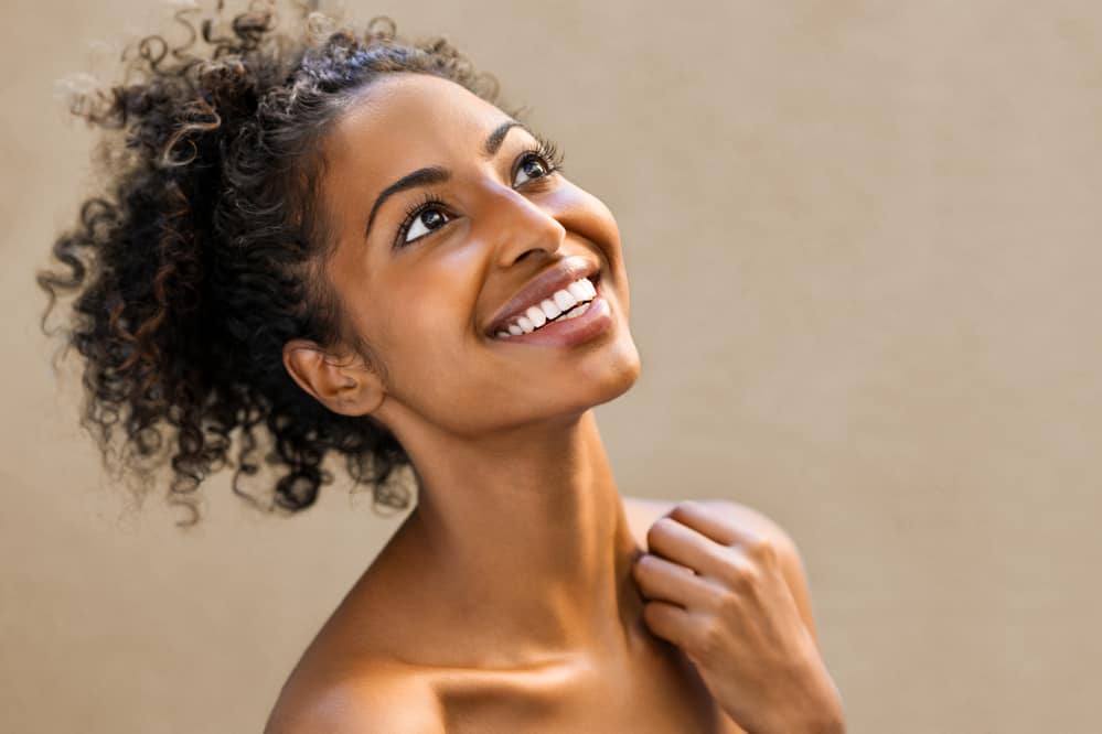 A beautiful American lady with wavy hair decided to use a shampoo bar without harsh chemicals to clean her curls.