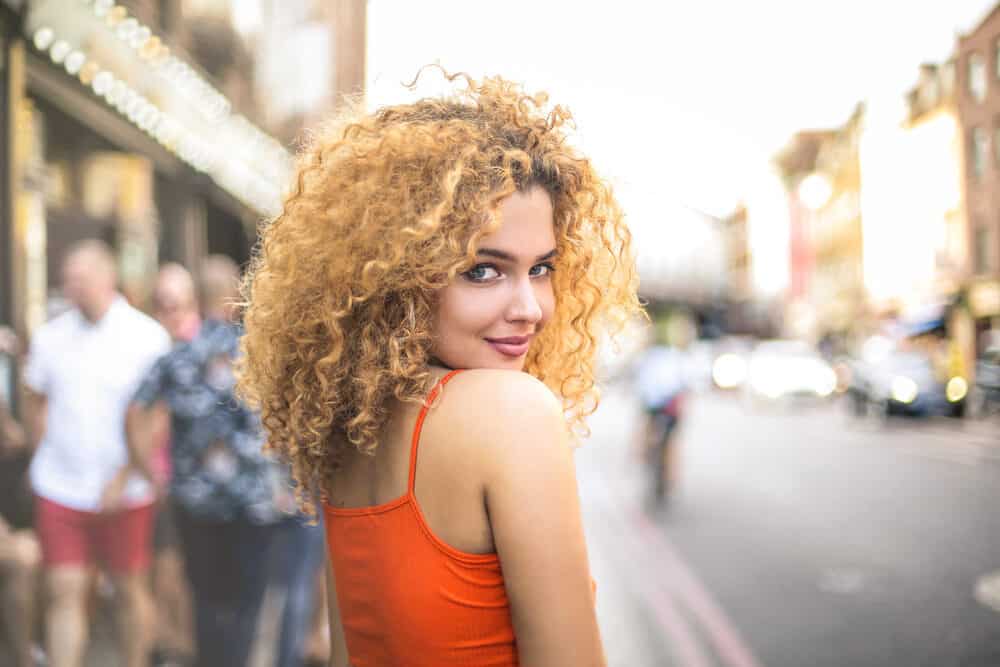 Cute girl smiling with overly warm pigments on blonde hair