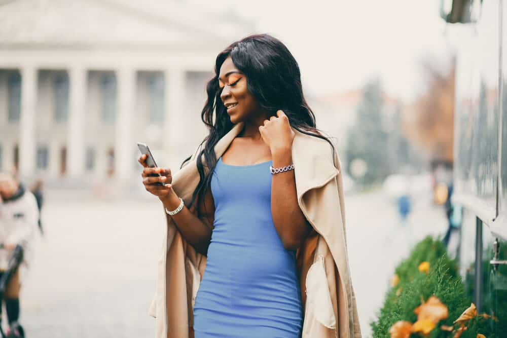 African American female wearing a blue dress with long black hair