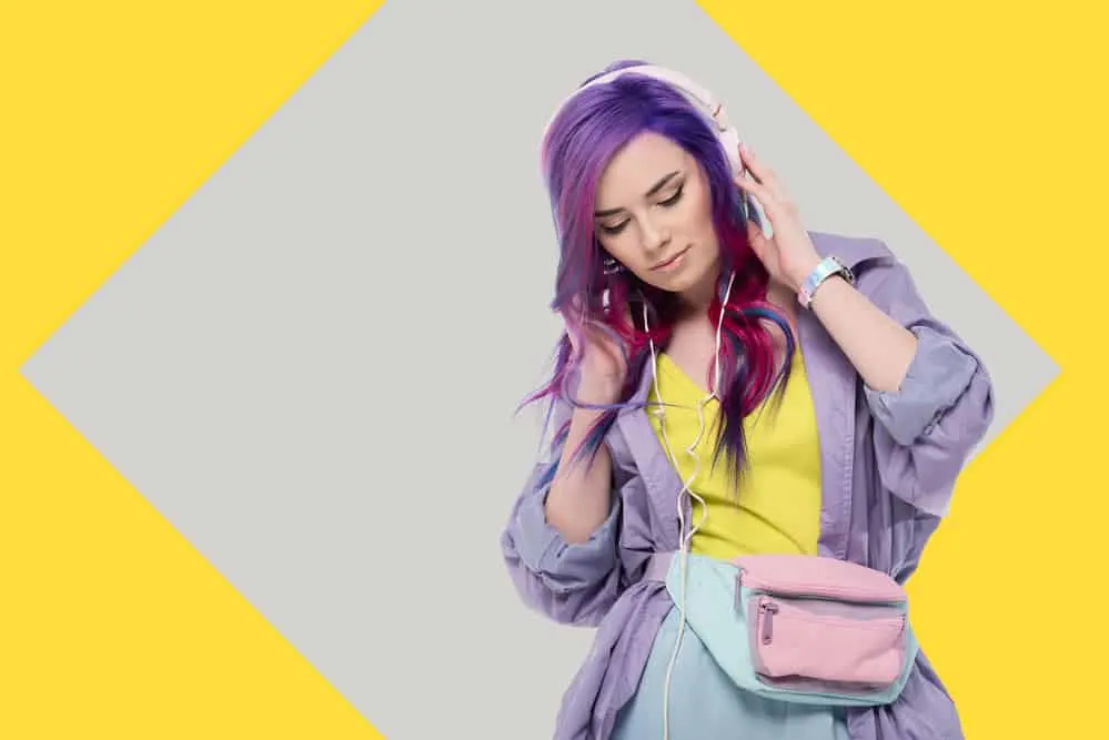 What Does Purple Hair Look Like When It Fades Over Time? 7 Young girl with multiple hair colors wearing a lavender jacket, yellow shirt, and faded blue pants.