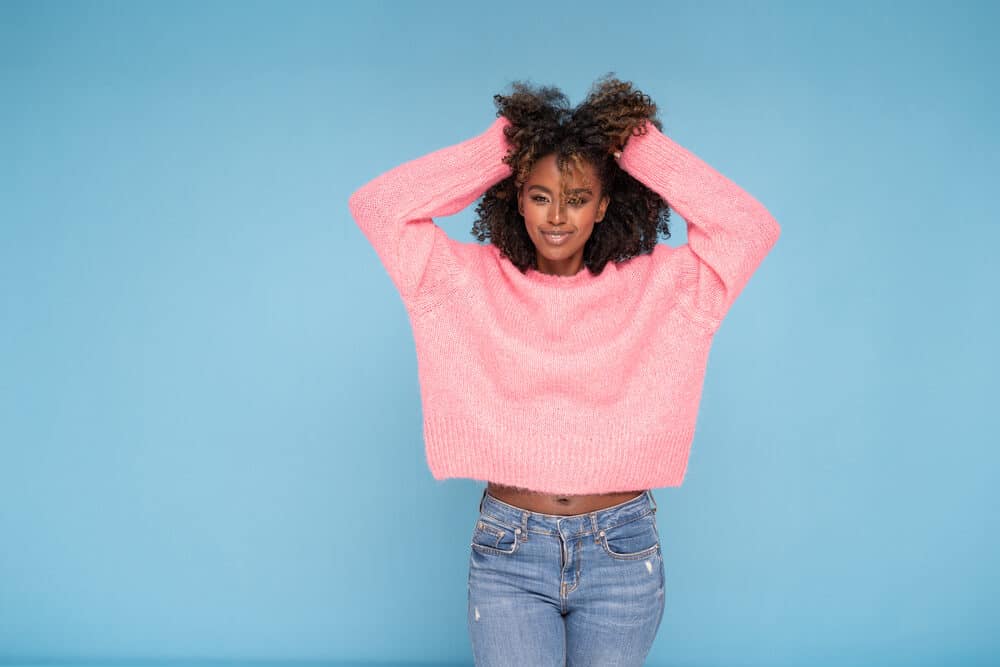 Cute African American female showing off chemically treated hair breaking-off after using Keratin Smooth shampoo