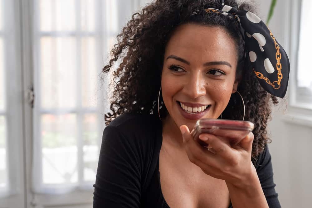 Black lady talking on the phone with her friends