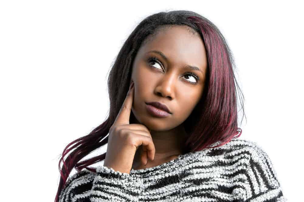 African American lady with hair that's a black natural color that's been colored red with cheap hair dye.