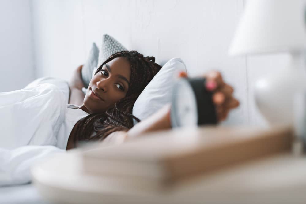 Woman waking up in the morning after wearing an overnight hairstyle.