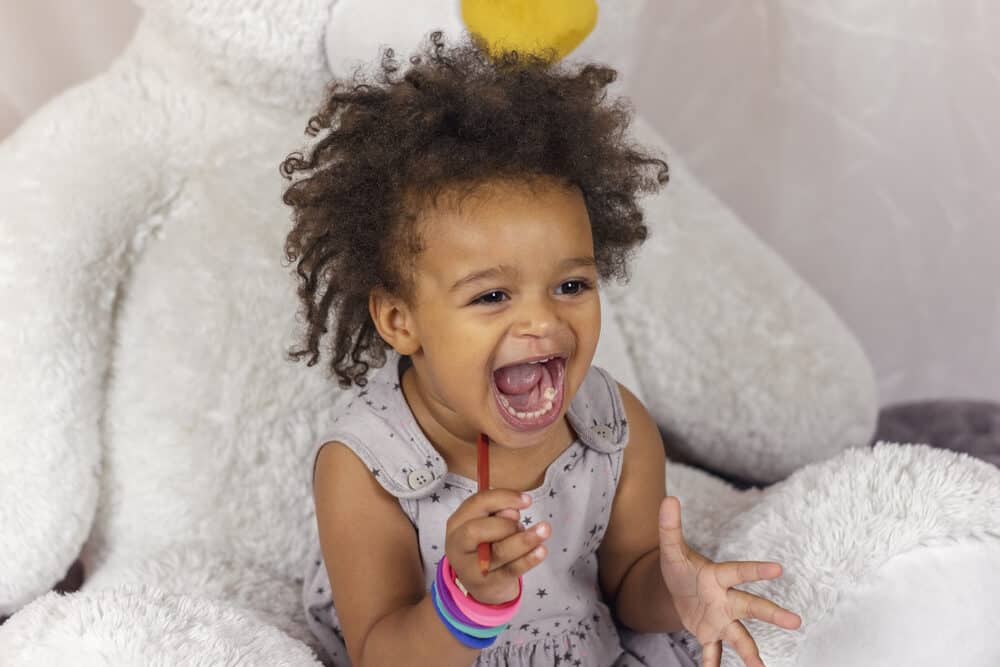African American kid with slime putty on her hands 