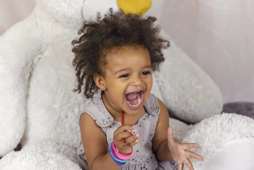 How To Get Slime Out Of Hair With Our Easy Step-by-Step Guide 4 African American kid with slime putty on her hands