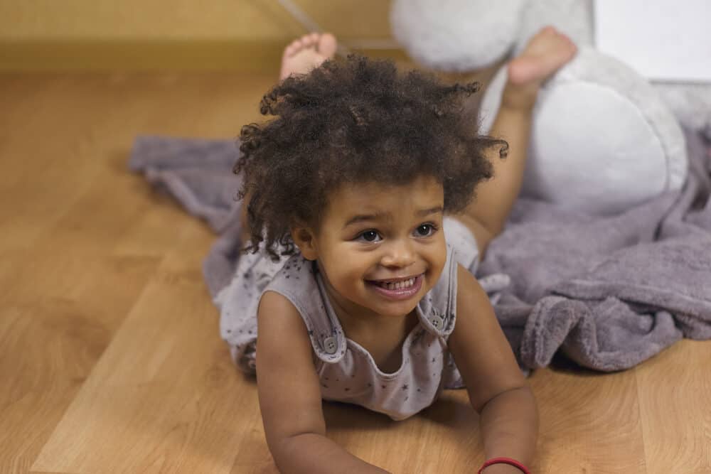 Pretty baby girl with greasy oil marks on her face