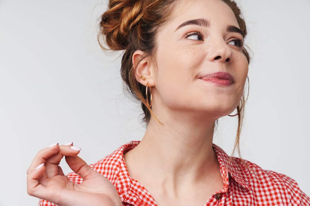 Cute lady with a playful pose after blow-drying her hair and scalp