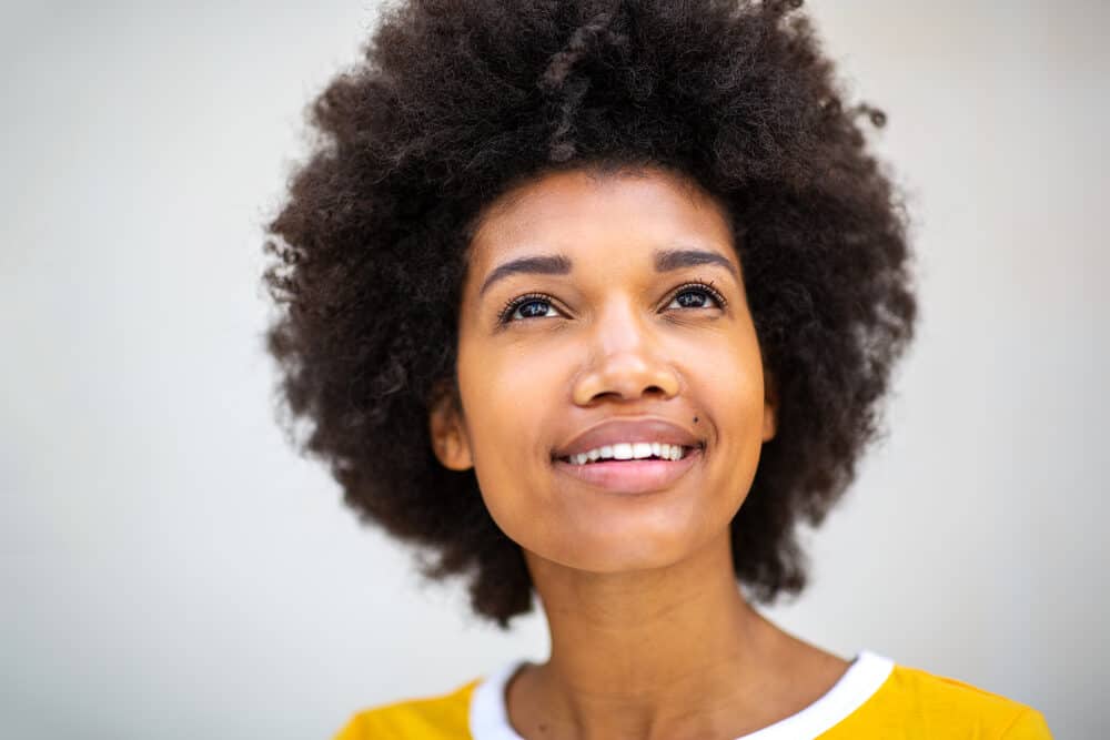 African American female with a 4C hair type showing off her well-defined curls.