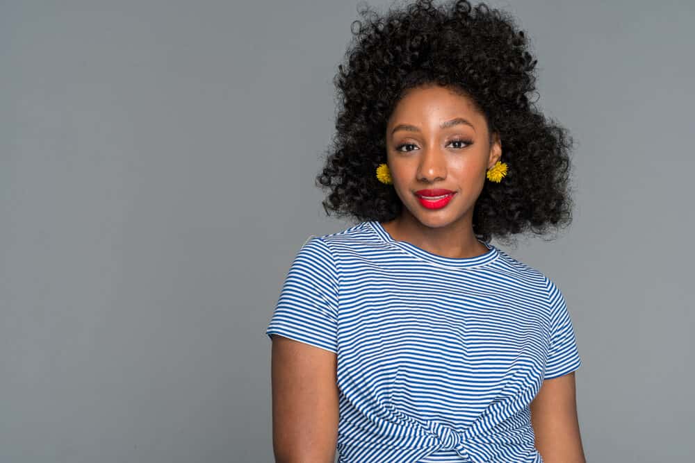Young African American woman with off black color hair extensions and natural makeup 