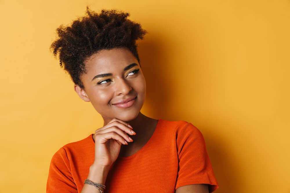 Beautiful African American female with silicone-free hair treated with coconut hair oil