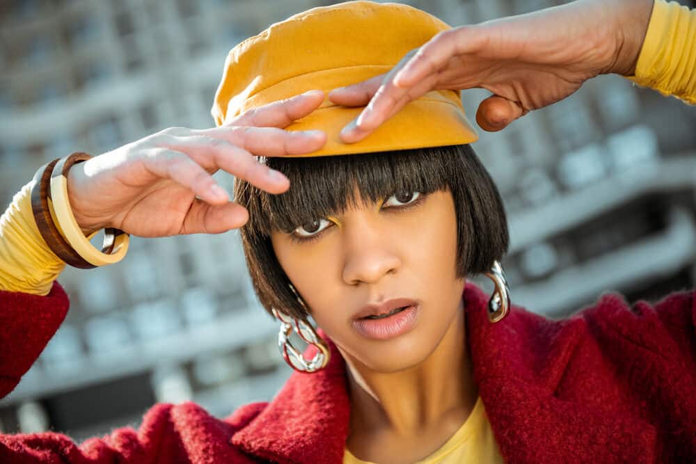 African American model wearing a cotton blend jacket and an orange hat