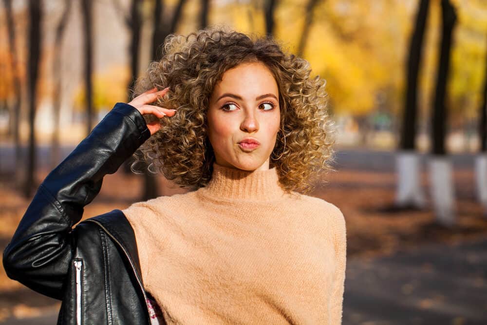 A cute lady wearing a leather jacket with a traditional perm hair treatment