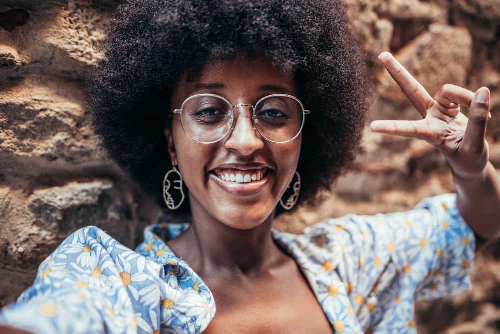 African American lady with textured hair celebrating her hair growth journey