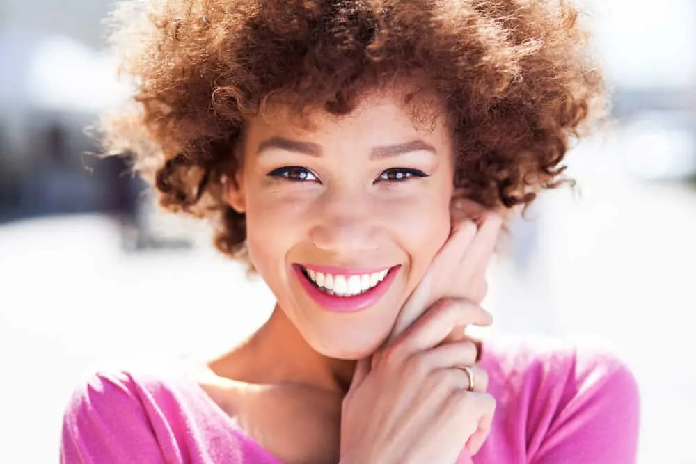The Best Purple Hair Dye for Dark Hair Plus Alternatives 1 Cute black girl with purple dye on naturally curly dark brown hair