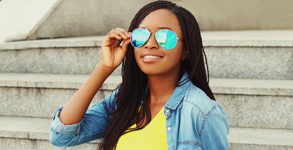 Black lady wearing shades and a great protective style on a 4C hair type