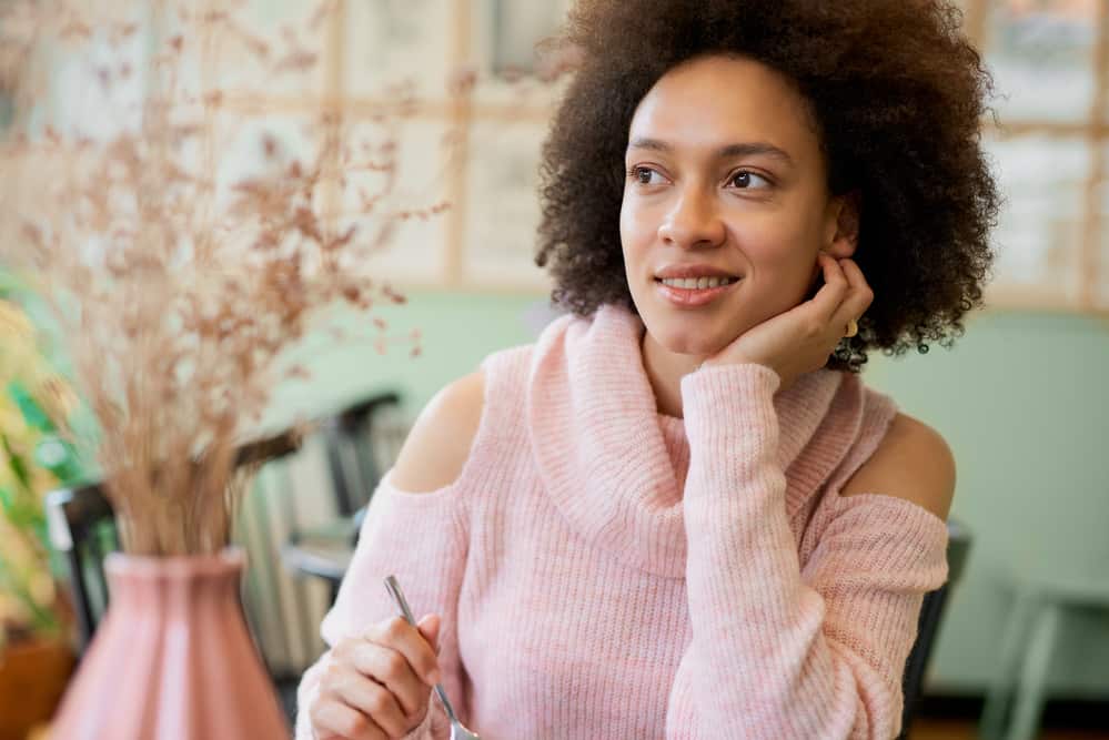 Mixed race woman with colored hair smiling after using Neutrogena anti-residue shampoo