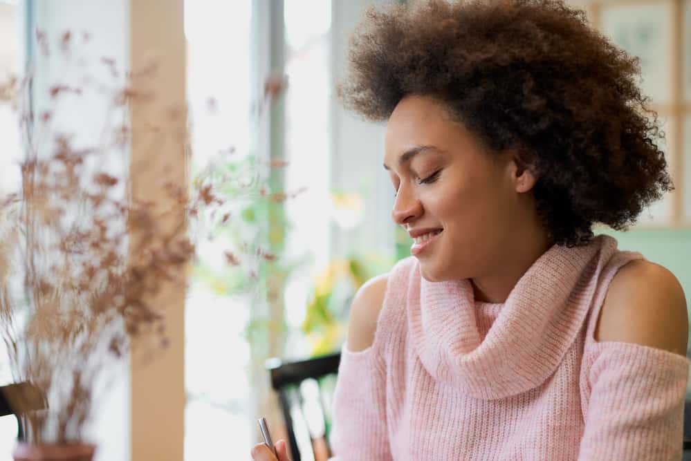 Cute African American woman with caramel skin and curly natural hair