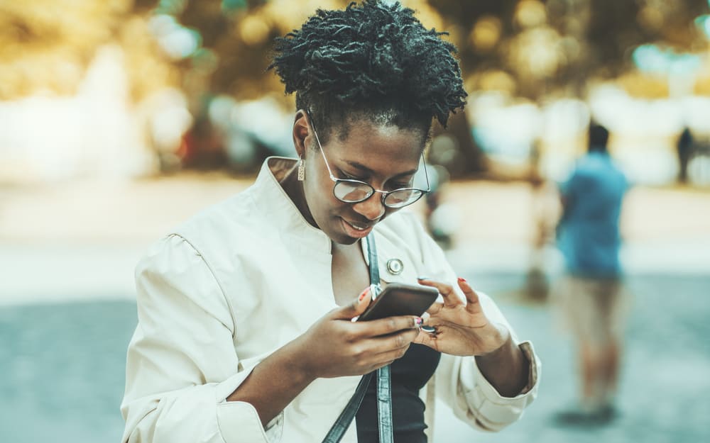 Cute African American wearing eyeglasses with starter micro locs on 4D natural hair.