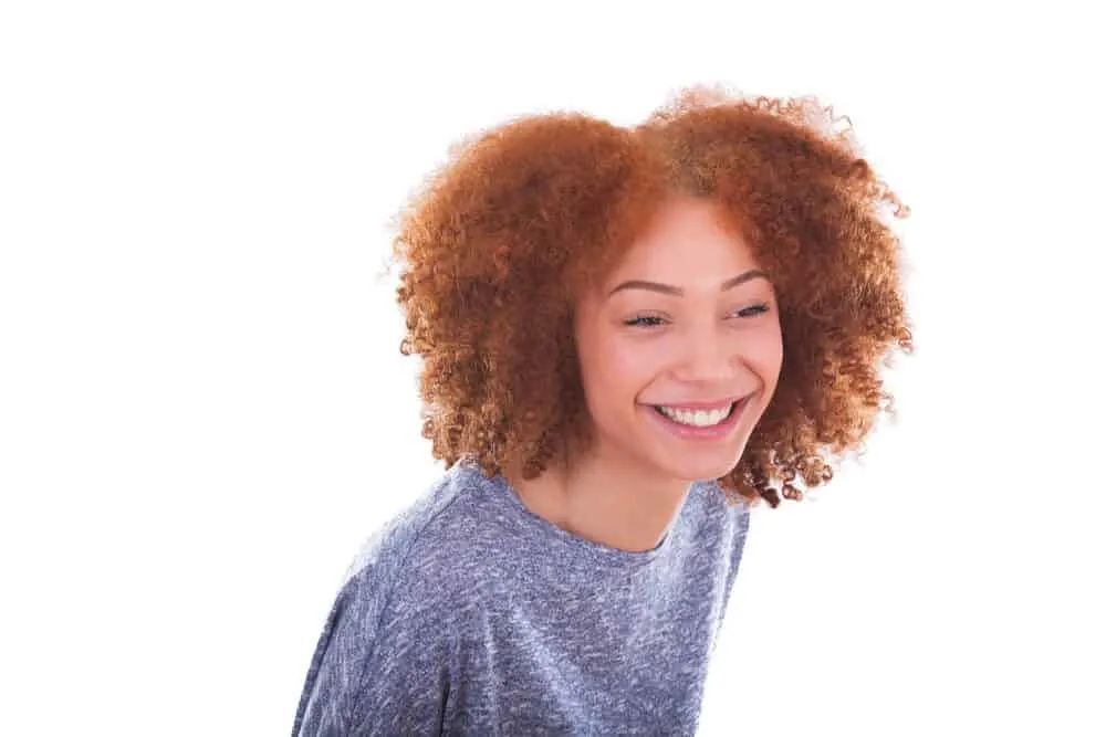 Can Black People Have Red Hair? Common Factors and Misconceptions 9 A cute black girl with ginger red hair, green eyes, and fair skin that are predominantly white traits