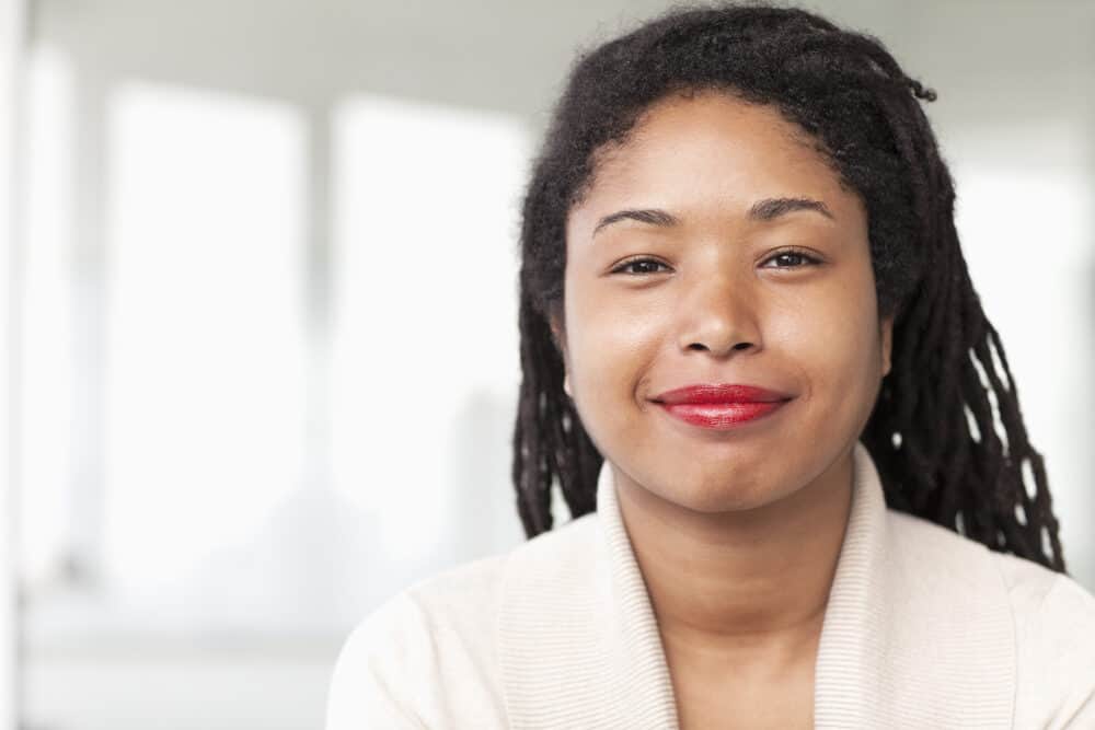 Cute young African American female wearing freeform locs on 4C natural hair