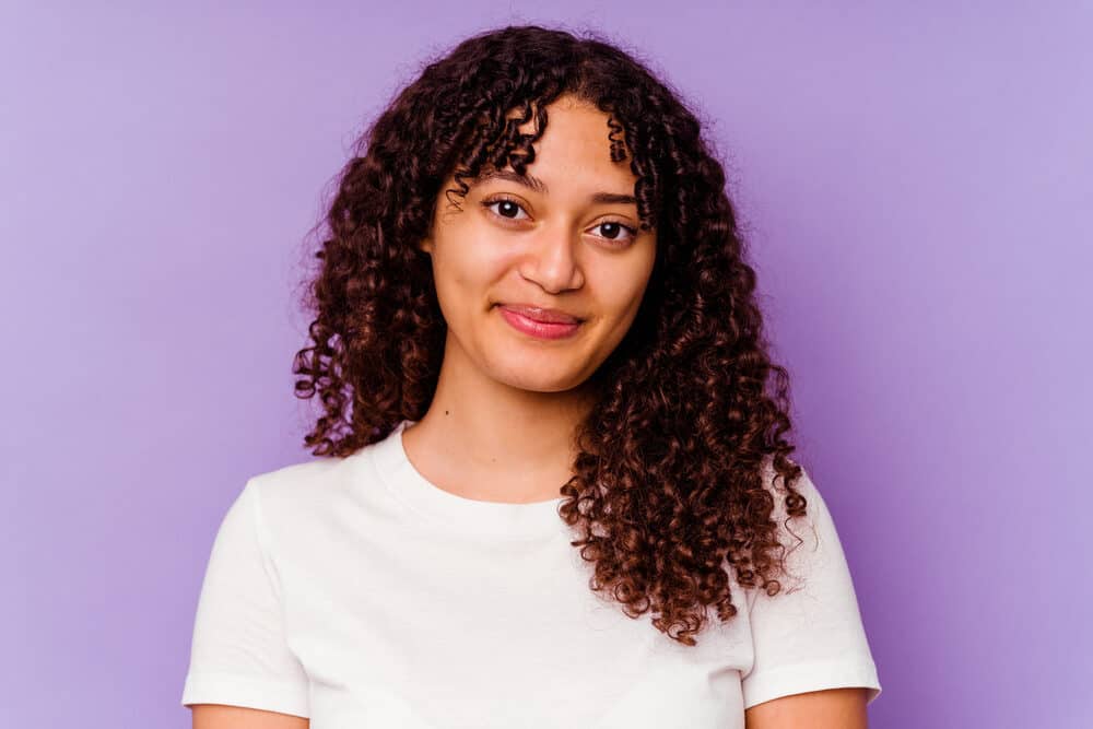 Young black woman with beautiful false lashes and liquid eyeliner wearing a white t-shirt