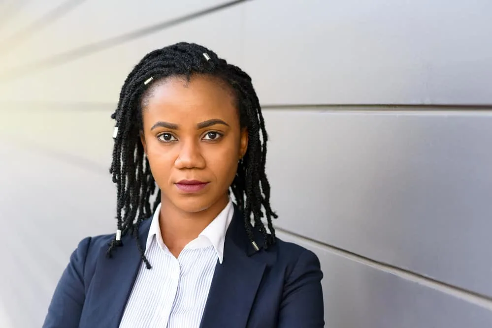 The 5 Different Stages of Locs: Baby, Budding, Teenage, Mature, and Rooted 3 African American lady wearing thinning locs with several excessive frizz and weak spots