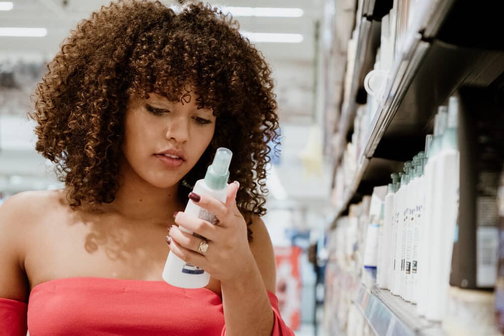 Female reviewing the ingredients of a moisturizer that includes citric acid