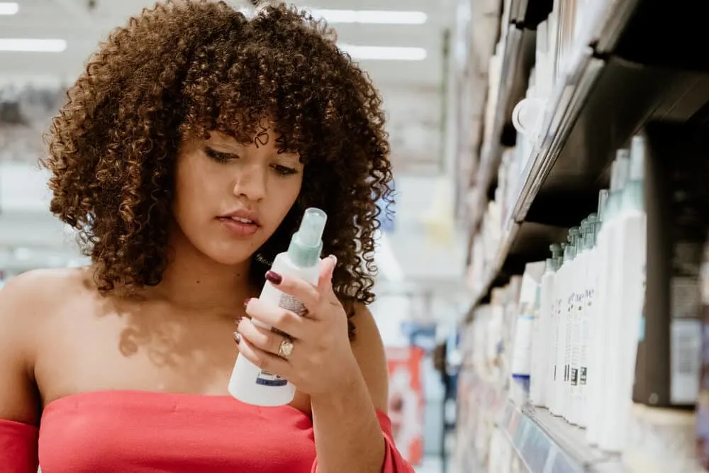 Is Garnier Fructis Good for Your Hair? What About Curly Hair? 3 Female reviewing the ingredients of a moisturizer that includes citric acid