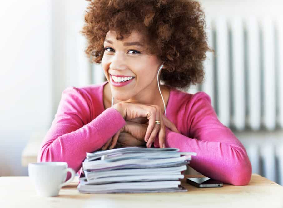 Black girl with light brown hair wearing a bright purple shirt