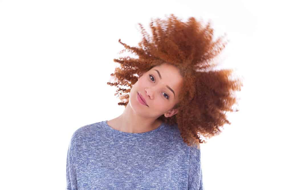 African female with curly red locks, an uncommon gene mutation among African populations