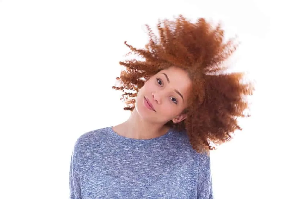 Can Black People Have Red Hair? Common Factors and Misconceptions 4 African female with curly red locks, an uncommon gene mutation among African populations