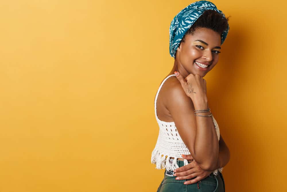 Happy African American woman wearing a white shirt and blue jeans