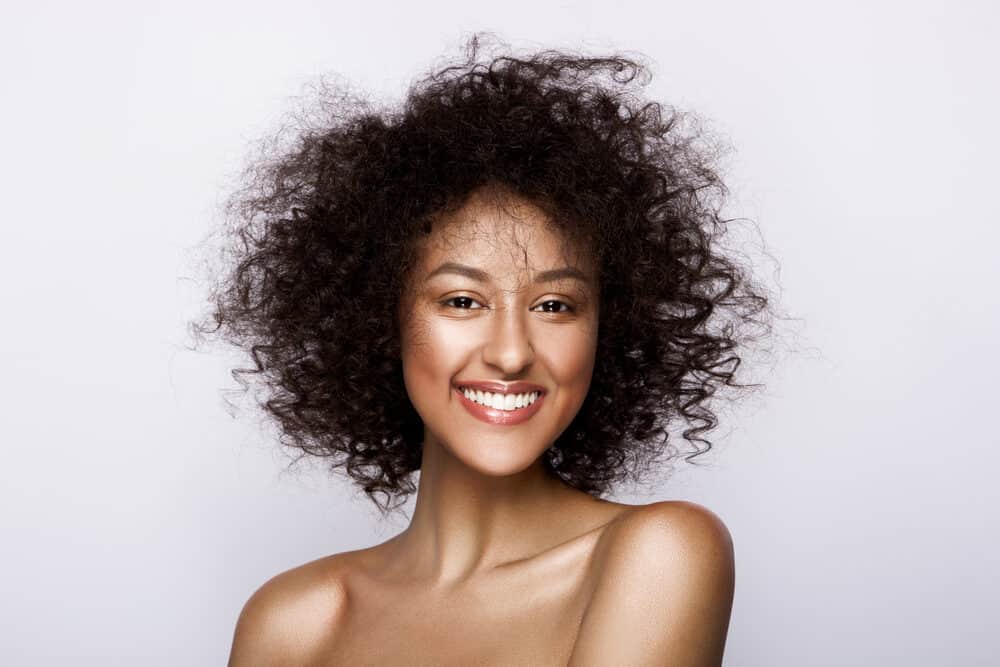 Cute African American female with type 3 curly hair strands