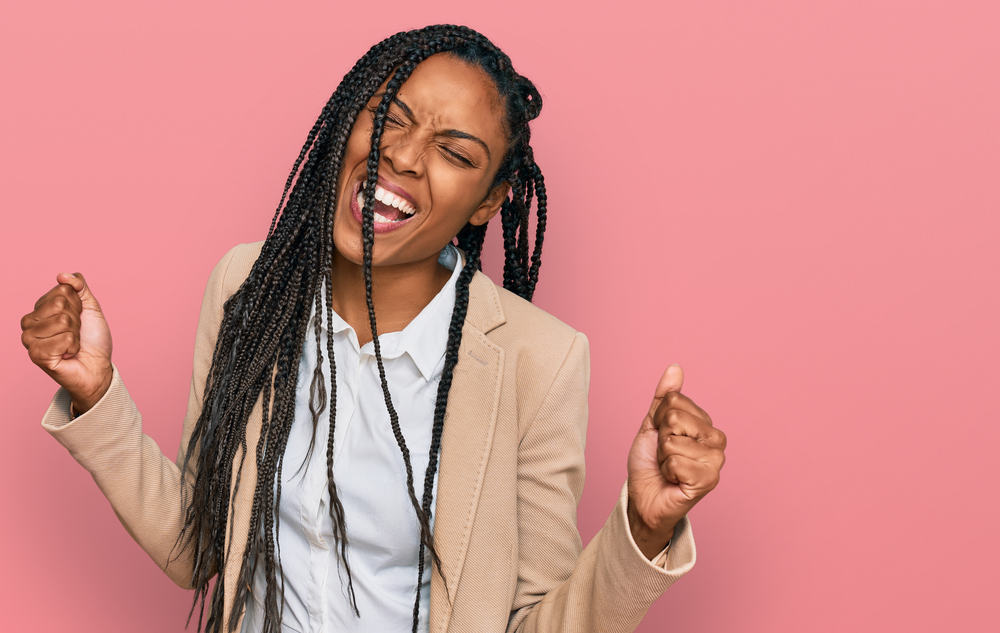 Cute African American lady wearing a yarn braid style on a 4C hair type