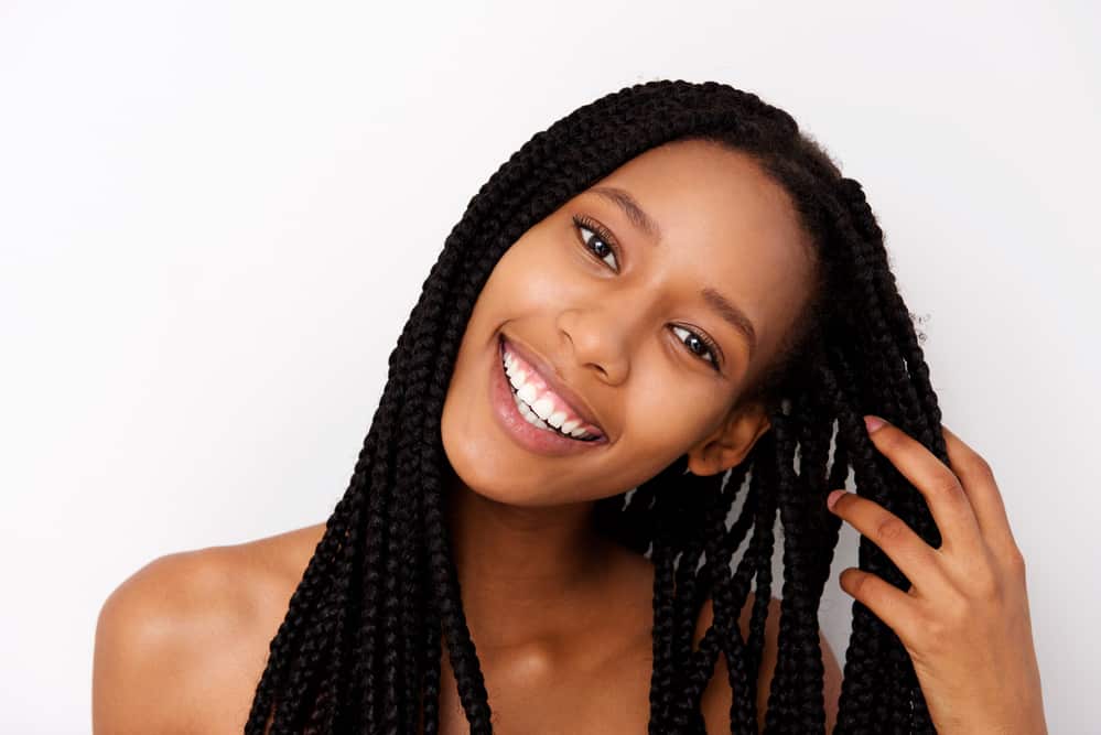 Pretty black lady wearing box braids preparing to play water sports