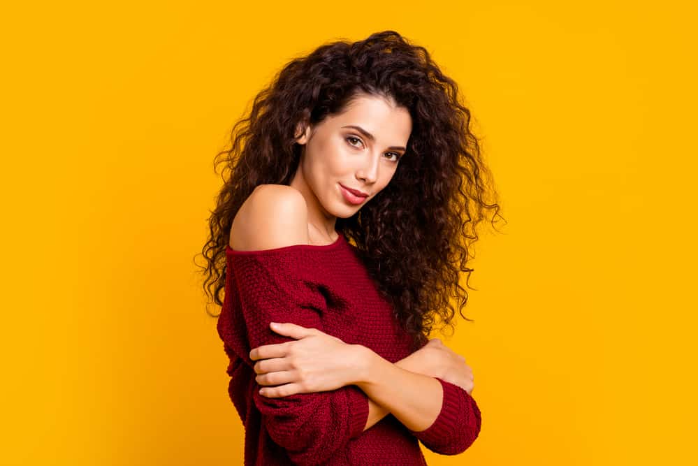 Beautiful female long hair rocking a root perm style with a casual fall sweater