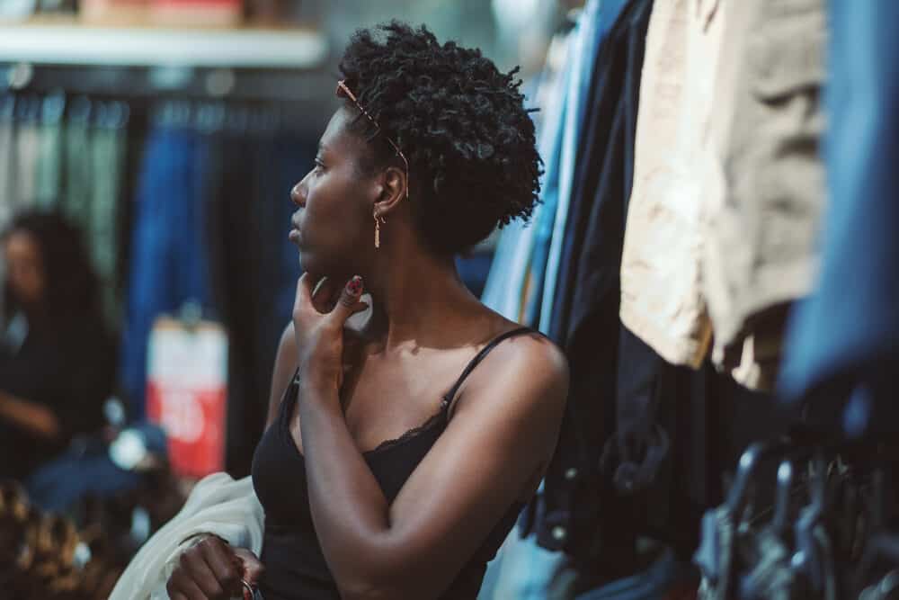 Cute young black lady with three-strand plaits wearing a common natural hairstyle