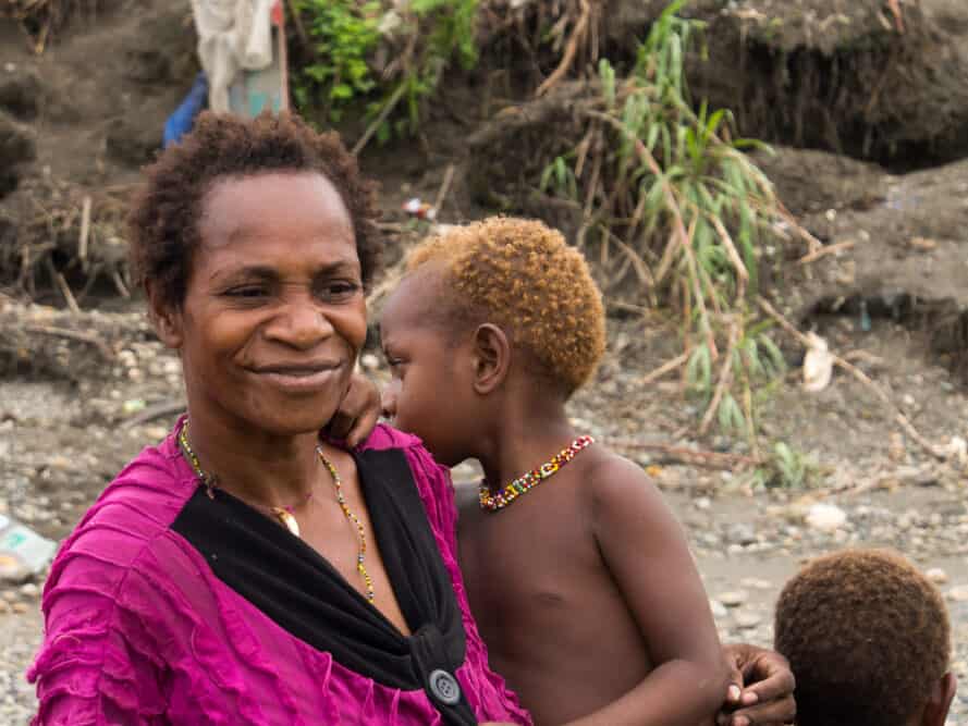 Mom and son showing blond hair samples that are a common part of their genetic heritage